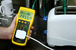 portable appliance tester being used